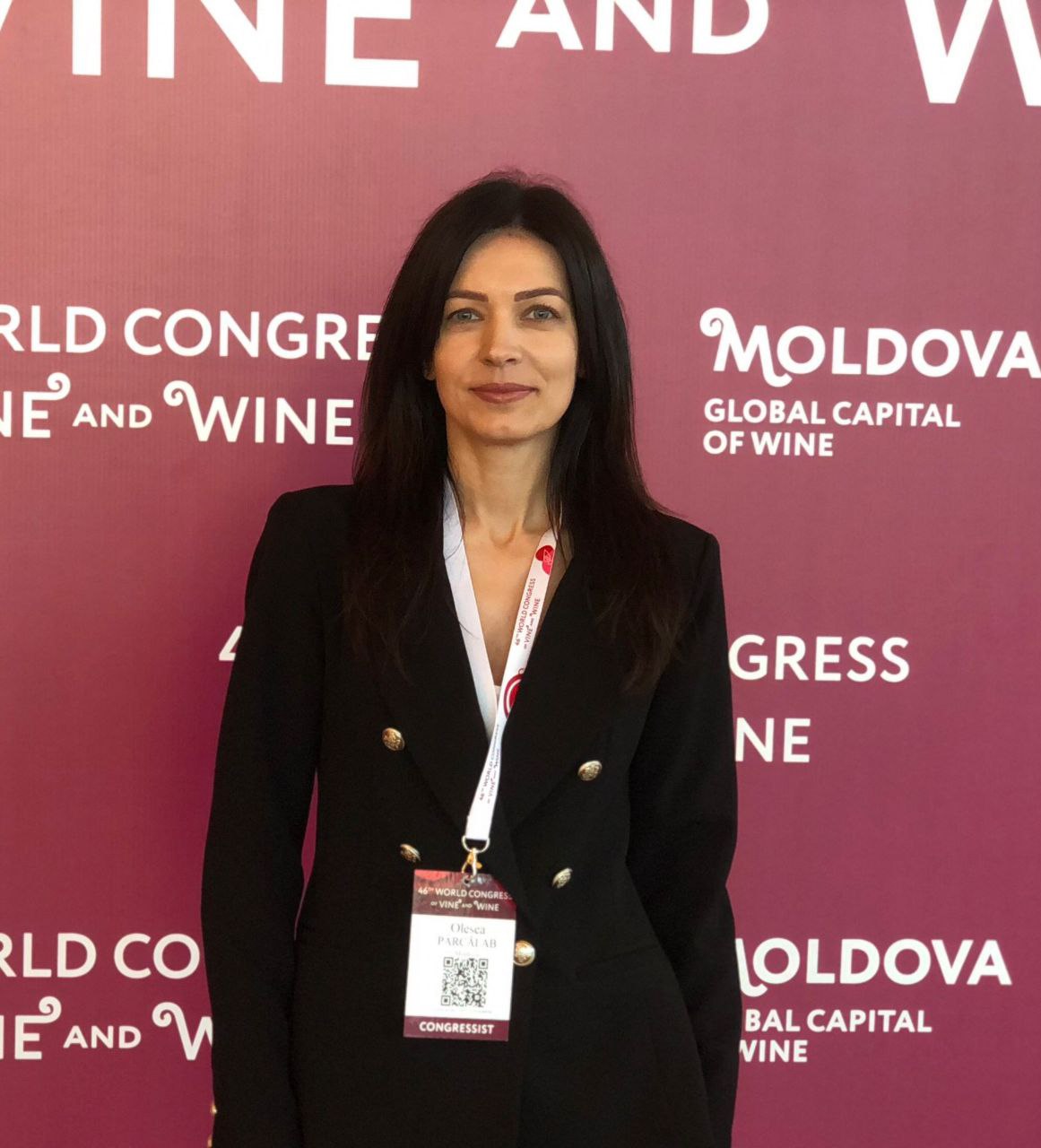 Portrait of Elena Zuza with long hair, wearing a light top